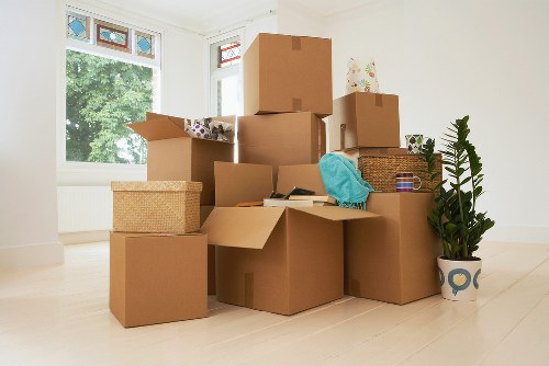Removal team planning a move with boxes and wrapped furniture